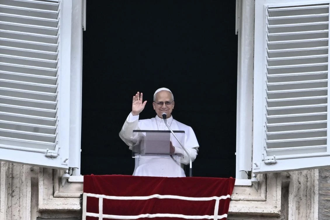 Pope Leo XIV greets the pilgrims gathered in St. Peter's Square during the Sunday Angelus prayer at the Vatican on March 15, 2026. (Photo by Filippo MONTEFORTE / AFP)
