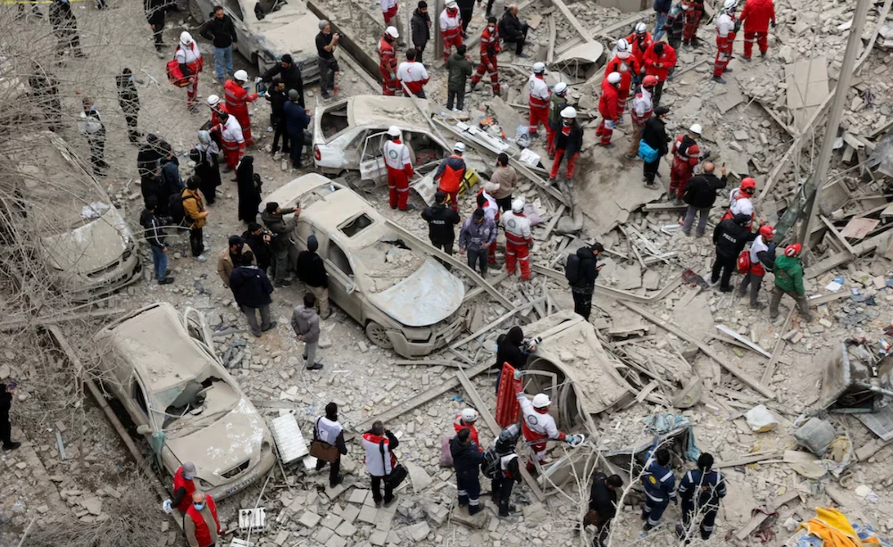Emergency personnel work at the site of a strike on a residential building, amid the US-Israeli conflict with Iran, in Tehran, Iran, March 16, 2026. (WANA via Reuters)