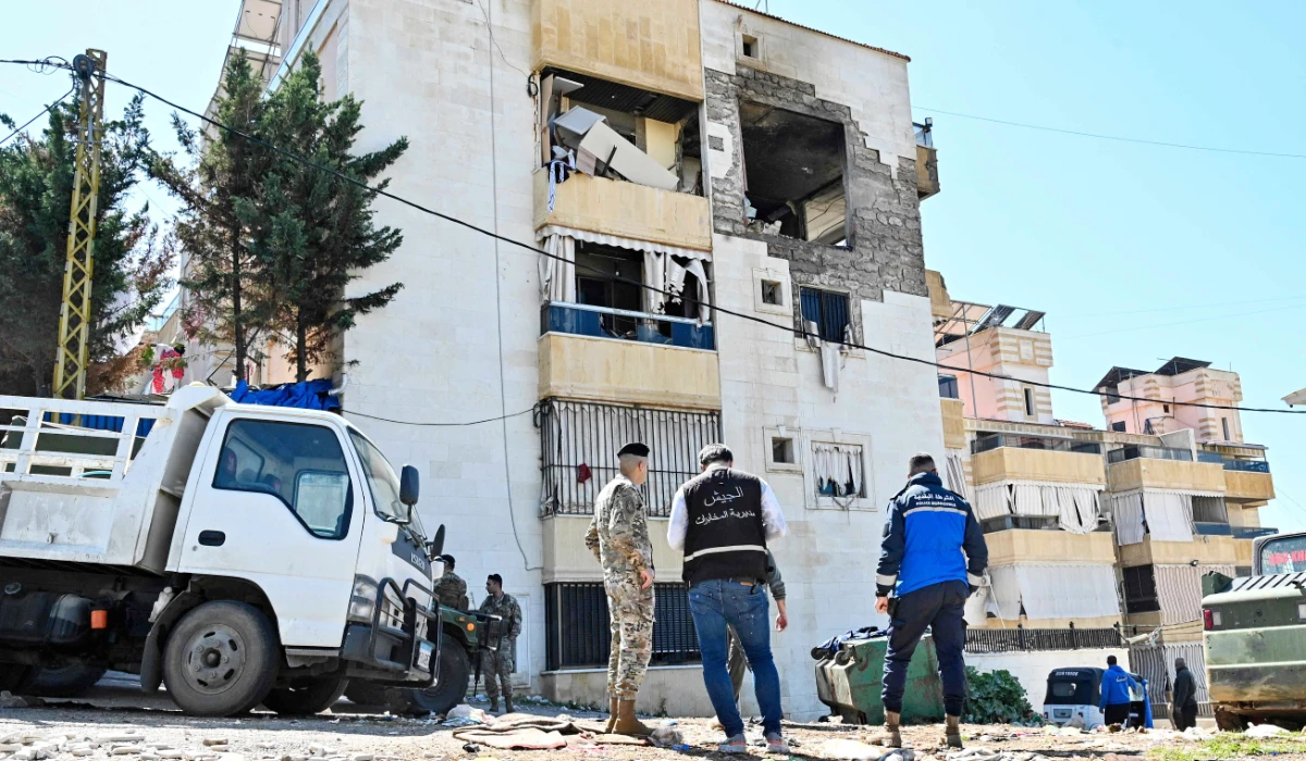 Lebanese army soldiers and police officers inspect a building that was targeted overnight by an Israeli air strike in Khalde, south of the Lebanese capital Beirut, on March 17, 2026. (AFP)