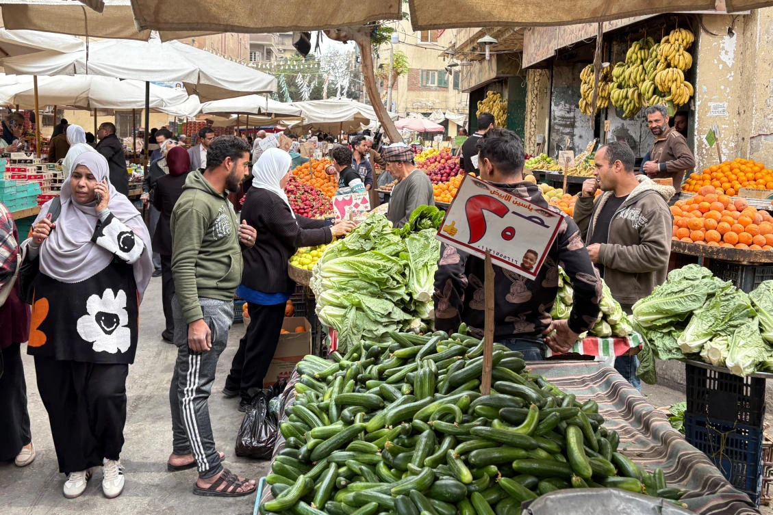 People buy vegetables at a popular market in Cairo, Egypt, Mar. 12, 2026. (AP)