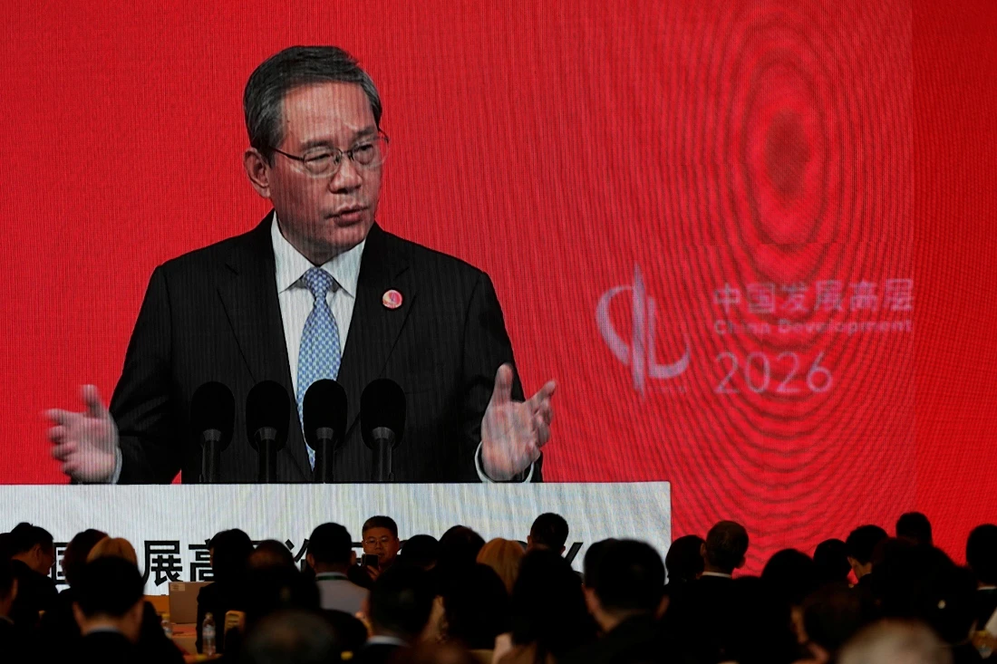 Chinese Premier Li Qiang on a big screen live broadcasting his speech at the opening of the China Development Forum 2026 held at the Diaoyutai State Guesthouse in Beijing, China. (Pool/Reuters)