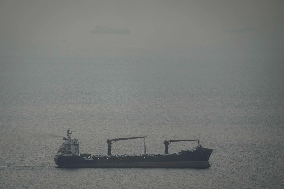 A cargo ship carrying vehicles sails through the Arabian Gulf toward the Strait of Hormuz in the UAE, March 22, 2026. (AP)
