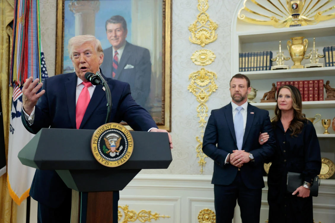 Markwayne Mullin stands next to his wife, Christie Mullin, as US President Donald Trump speaks, while they attend Markwayne Mullin’s swearing-in as Department of Homeland Security (DHS) Secretary, at the White House in Washington, Mar. 24, 2026. (Reuters)