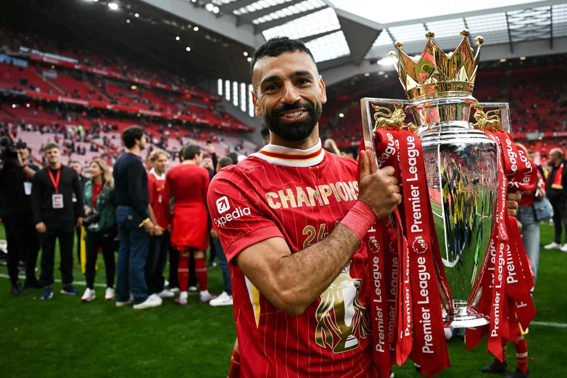 Liverpool’s Egyptian striker Mohamed Salah celebrates with the Premier League trophy at the end of their EPL match against Crystal Palace at Anfield in Liverpool, on May 25, 2025. ( AFP)