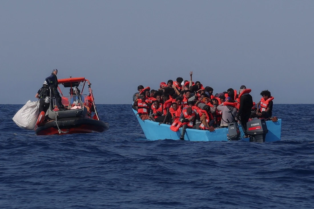 Migrants aboard an overcrowded boat react as they are approached by the crew of the migrant search and rescue ship Sea-Watch 5, during a rescue operation in the Search and Rescue zone in the central Mediterranean, off Libya. (Reuters)