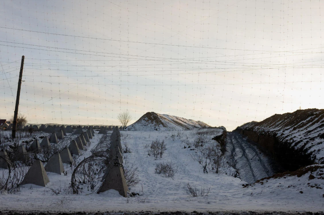 This photograph shows Dragon's Teeth (pyramidal anti-tank obstacles made from reinforced concrete) and coils of barbed wire as part of defense fortifications in a field at an undisclosed location in eastern Ukraine on January 19, 2026, amid the Russian invasion of Ukraine. (AFP)