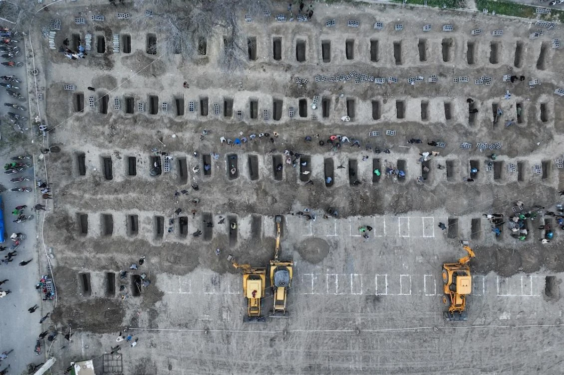 In this aerial handout picture released by the Iranian Press Center, mourners dig graves during the funeral for children killed in a reported strike on a primary school in Iran’s Hormozgan province in Minab on March 3, 2026. (FILE/AFP)