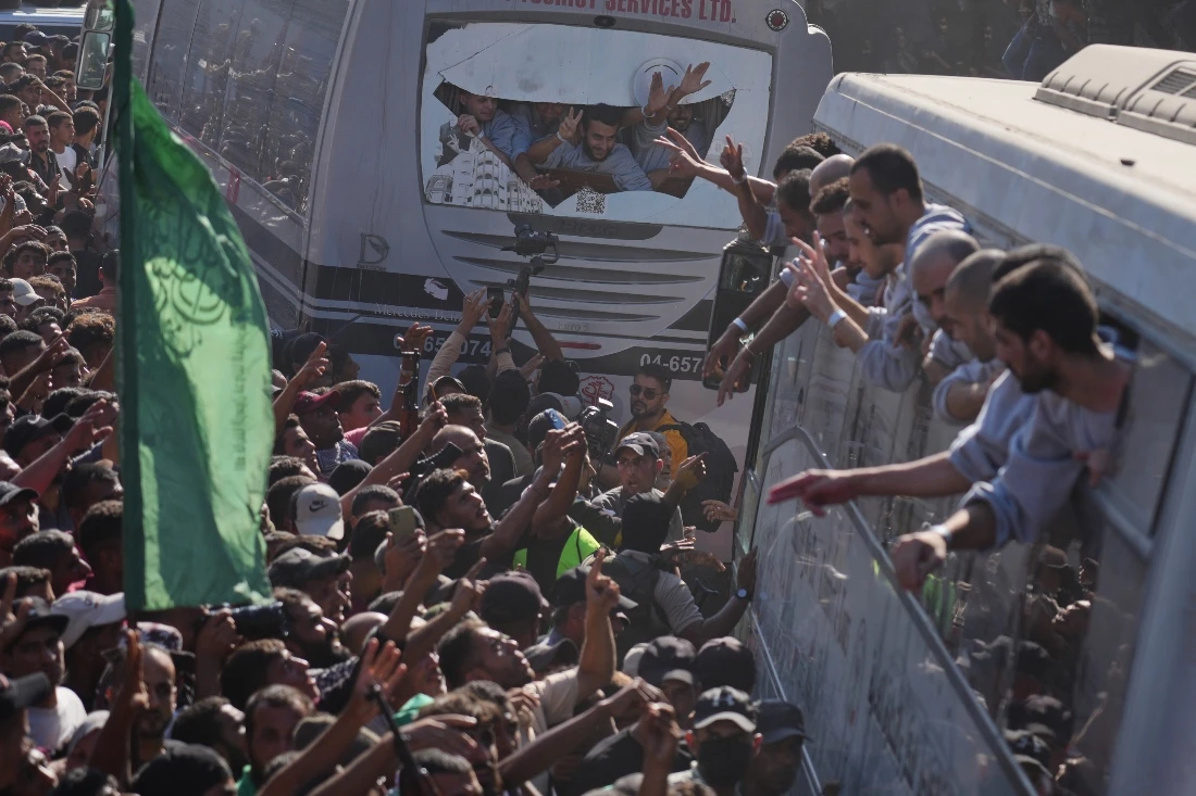 People gather to greet freed Palestinian prisoners arriving on buses in the Gaza Strip after their release from Israeli jails. (AP)