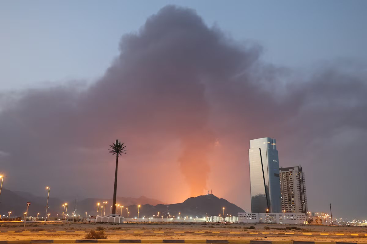 A tall plume of black smoke ascends following an explosion in the Fujairah industrial zone in the UAE. (AFP)