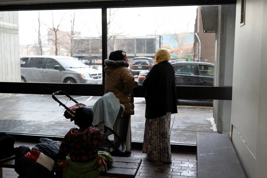 Somali residents look out of the lobby of the Riverside Plaza, in Minneapolis. (Reuters)