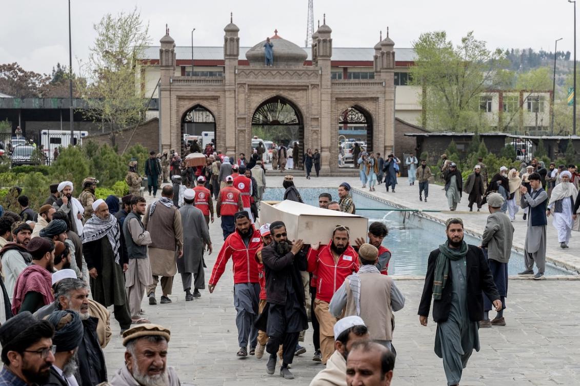 Afghan volunteers carry the coffins of victims killed by a Pakistani airstrike that struck a drug rehabilitation center, during the second mass funeral prayer ceremony at the Eid Gah Mosque in Kabul on March 26, 2026. (FILE/AFP)