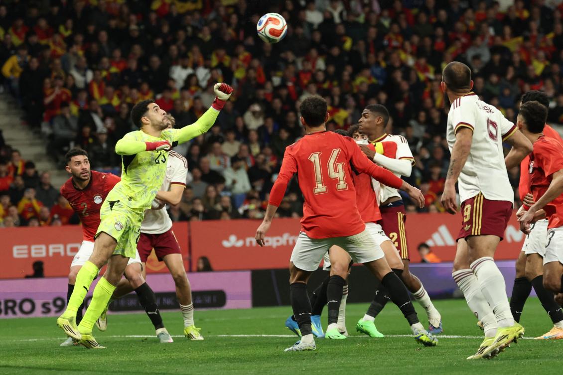 Egypt's goalkeeper #23 Mostafa Shobeir (L) hits the ball during the international friendly football match between Spain and Egypt at RCDE Stadium in Cornella de Llobregat, near Barcelona, on March 31, 2026. (Photo by Lluis GENE / AFP)