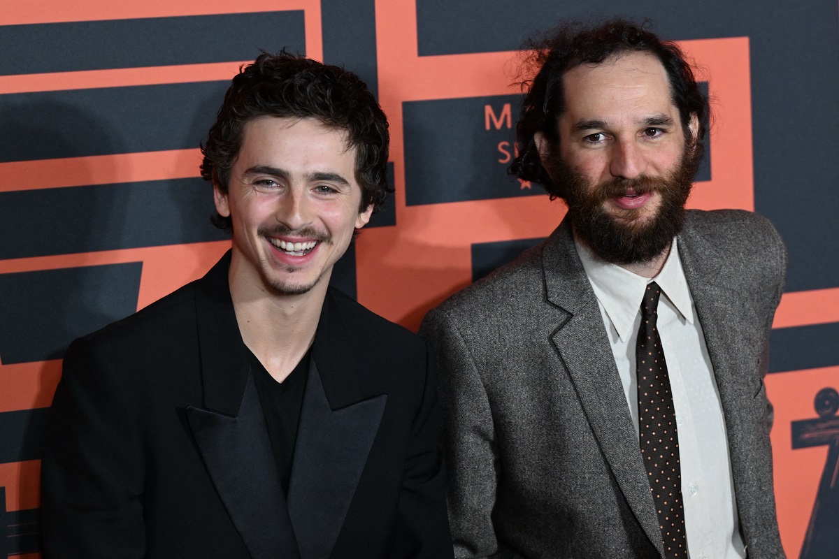 Timothée Chalamet (L) and film director Josh Safdie pose upon arrival on the red carpet for screening of their film "Marty Supreme" in Beijing on March 10, 2026. (AFP)
