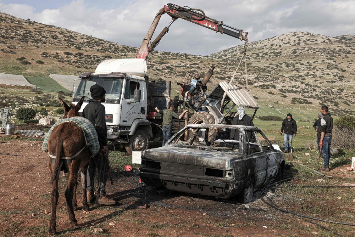 Palestinians inspect a burned vehicle and tractor following an Israeli settlers attack in the northen outskirts of Tayasir village near the occupied West Bank town of Tubas, March 31, 2026. (AFP)