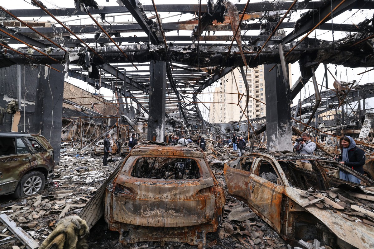 The wreckage of vehicles in a car service center in eastern Tehran that was hit by a missile strike, March 28, 2026. (AFP)
