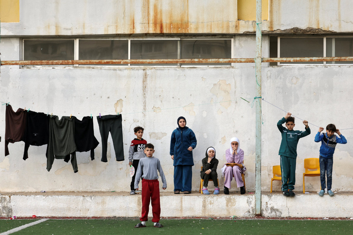 A group of displaced children gather within the grounds of Jaafareya High School in Tyre, Lebanon, on March 27, 2026. The school is now used as a temporary shelter for displaced people, amid escalating hostilities between Israel and Hezbollah. (REUTERS)