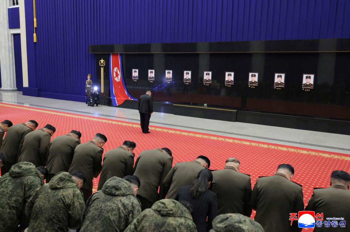 North Korean leader Kim Jong Un pays his respects in front of portraits of fallen North Korean soldiers, killed during their overseas deployment in Russia’s Kursk region, in this picture released on Dec. 13, 2025. (KCNA via KNS/AFP)