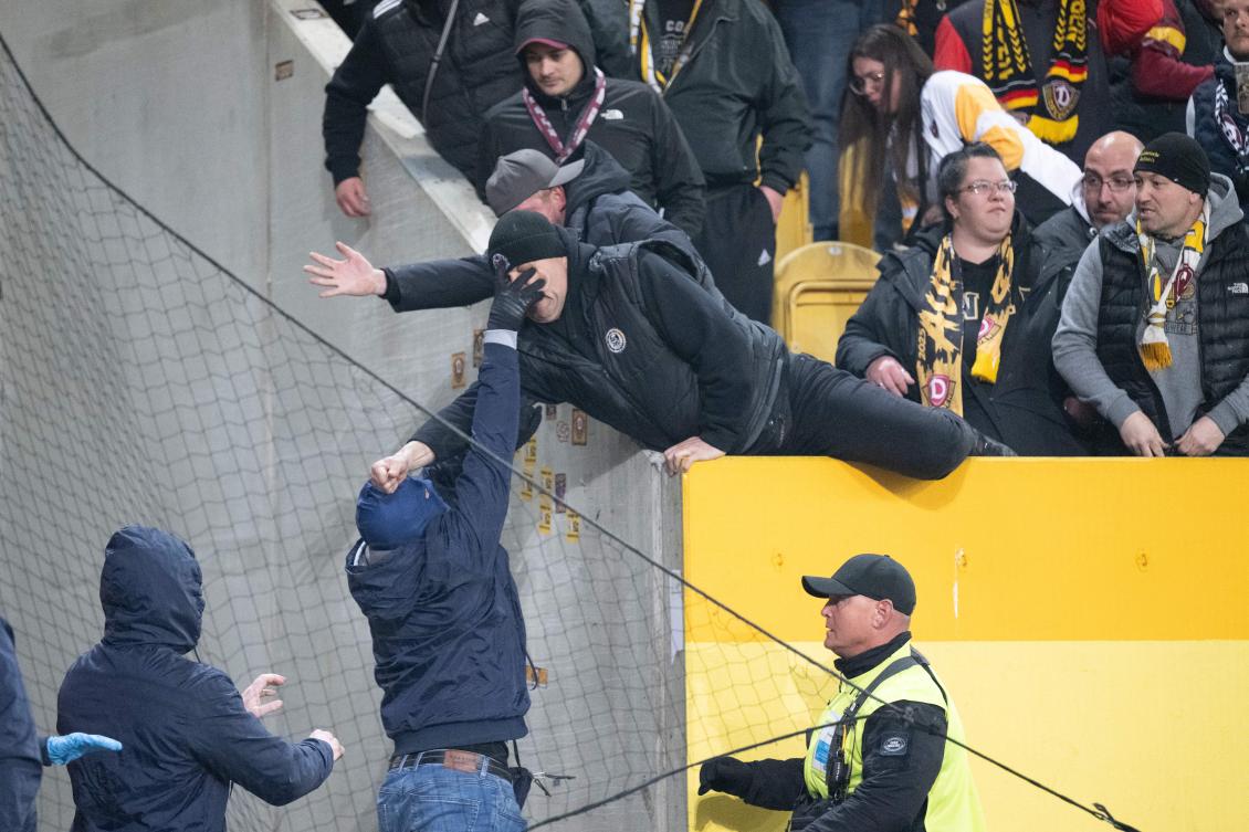 Police chase fans off the field in clashes at German club game in Dresden