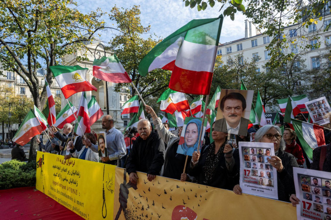 Protesters wave flags of the National Council of Resistance of Iran (NCRI) during a demonstration by Franco-Iranian associations, including the Committee to Support Human Rights in Iran (CSDHI) against the capital punishment in Iran, a day after the World Day Against the Death Penalty, in central Paris on October 11, 2025. (AFP)