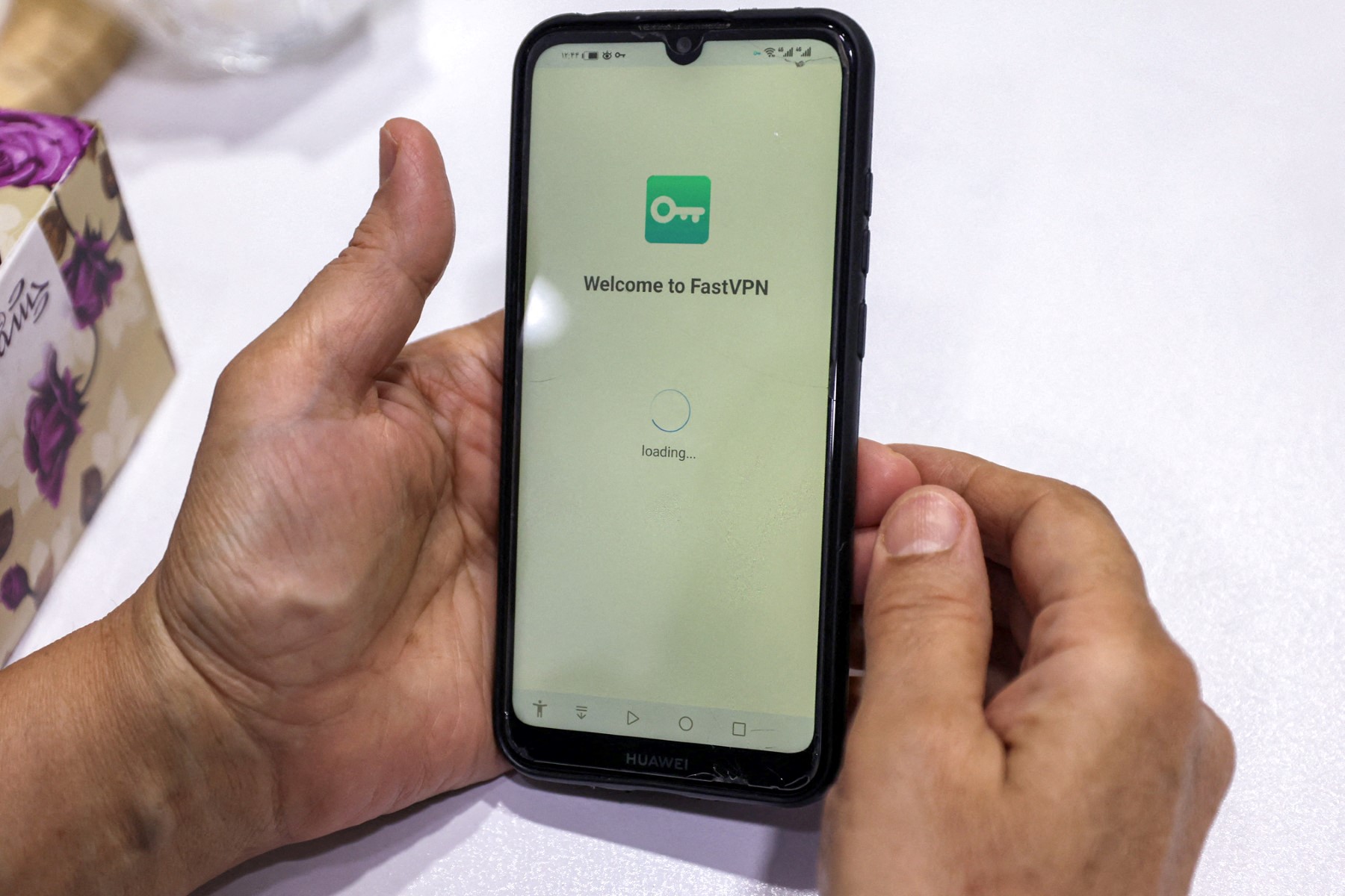 A person holds a phone after activating a virtual private network (VPN) service to access the internet while in Tehran, Iran. (AFP)