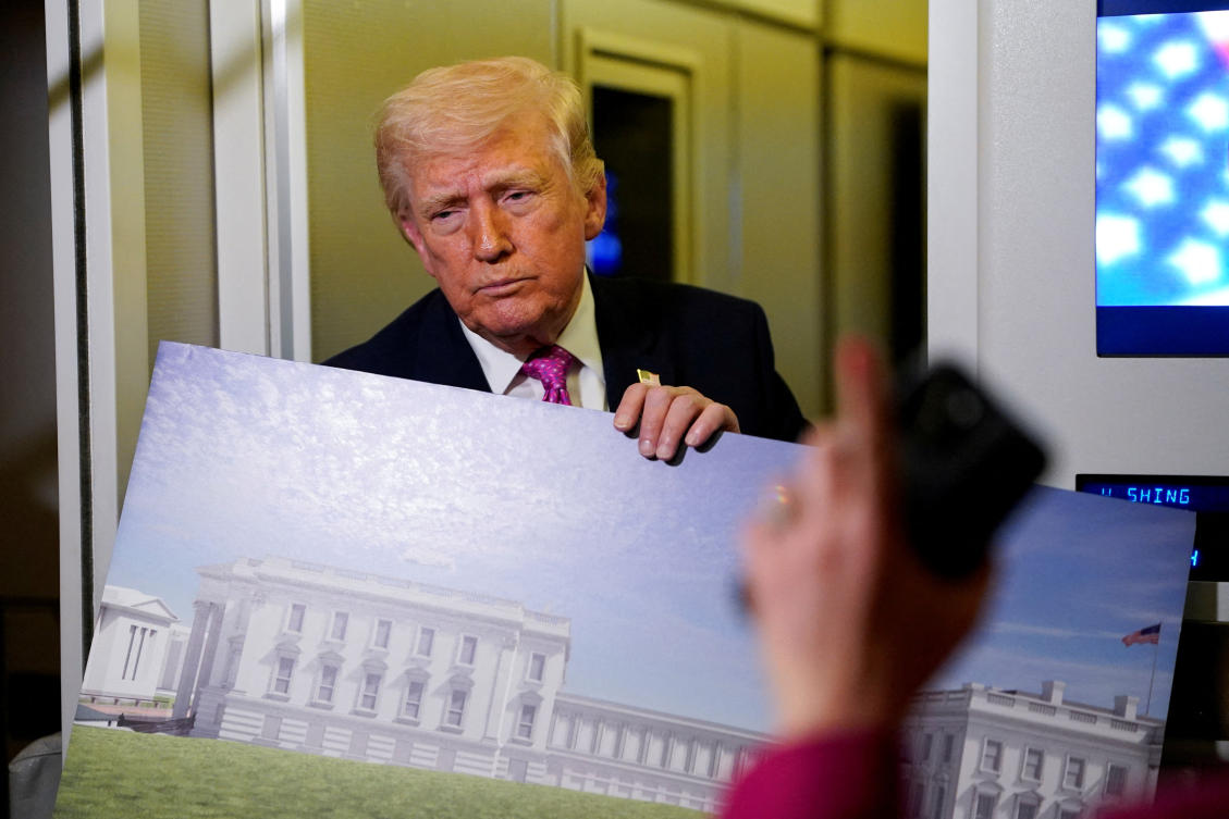 President Donald Trump holding up renderings of the planned White House ballroom, aboard Air Force One en route to Joint Base Andrews, Maryland last month. (Reuters/File)