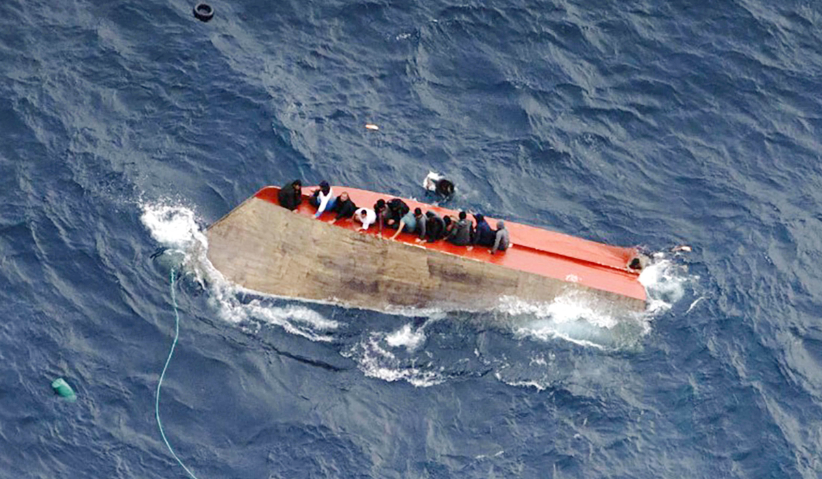 This photo taken on April 4, 2026 and handout on April 5, 2026 by German NGO Sea-Watch, shows migrants seatted on a capsized boat off Libya. (AFP)