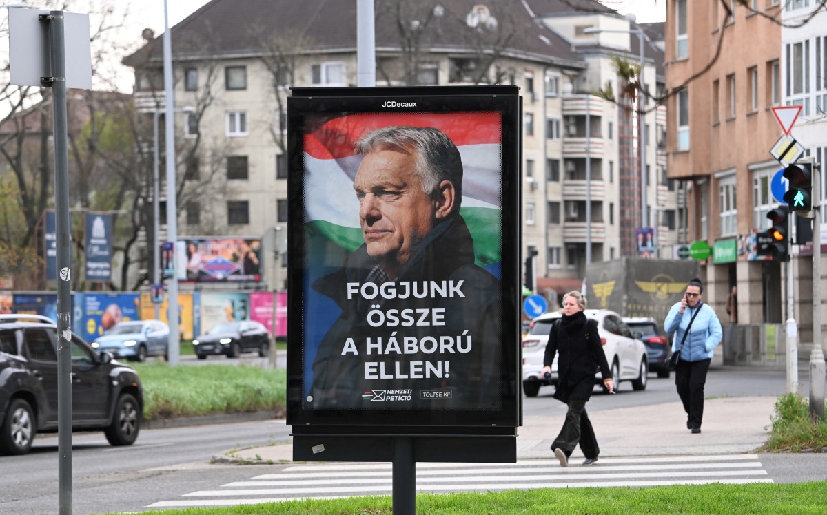 A billboard featuring a portrait of Hungarian Prime Minister Viktor Orban with the text reading, 'Let's get together against the war', is seen in Budapest, Hungary. (AFP)