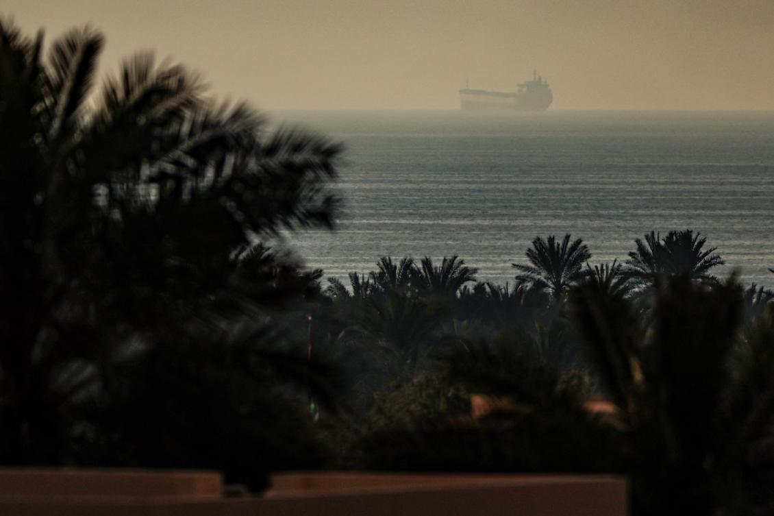 A photograph taken from the town of Al Jeer in the northern emirate of Ras Al Khaimah shows a tanker passing through the waters of the Strait of Hormuz on February 25, 2026. (FILE/AFP)