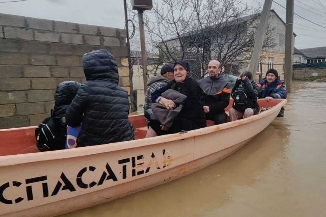 In this image made from video provided by Russian Emergency Ministry Press Service, Emergency Situations Ministry personnel evacuate people from a flood zone in the Derbent district of the Republic of Dagestan, Russia.