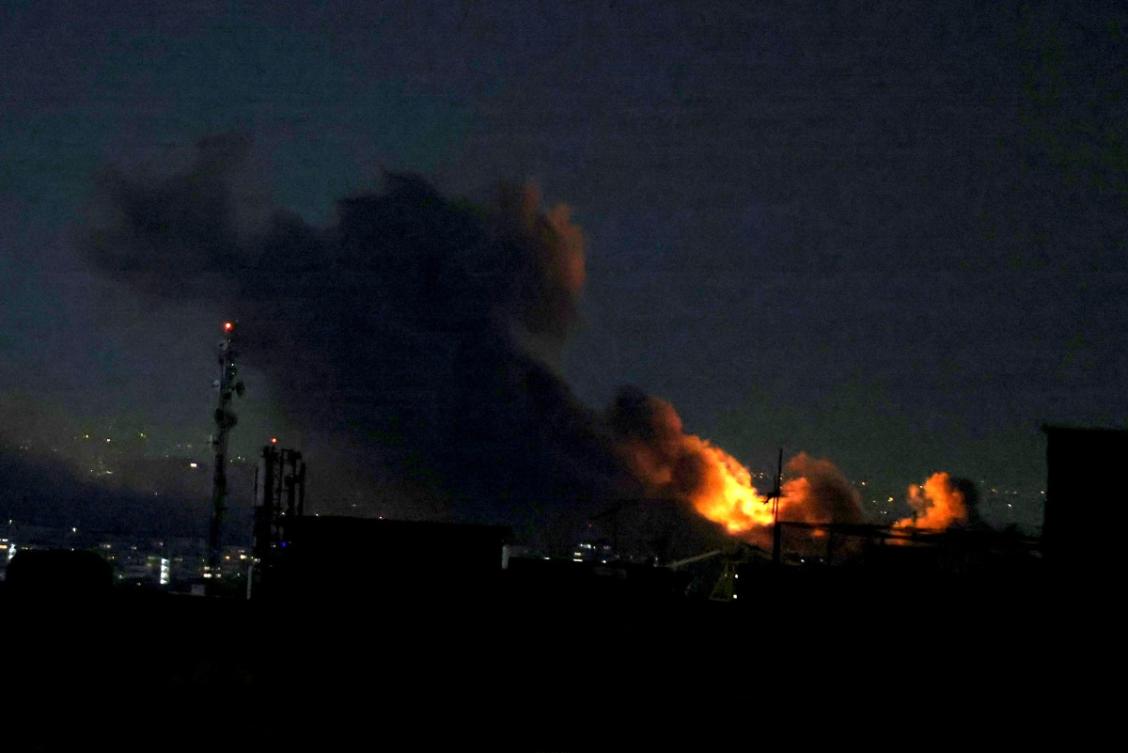 Above, a plume of smoke rises from the site of a strike in Tehran on March 29, 2026. (AFP)