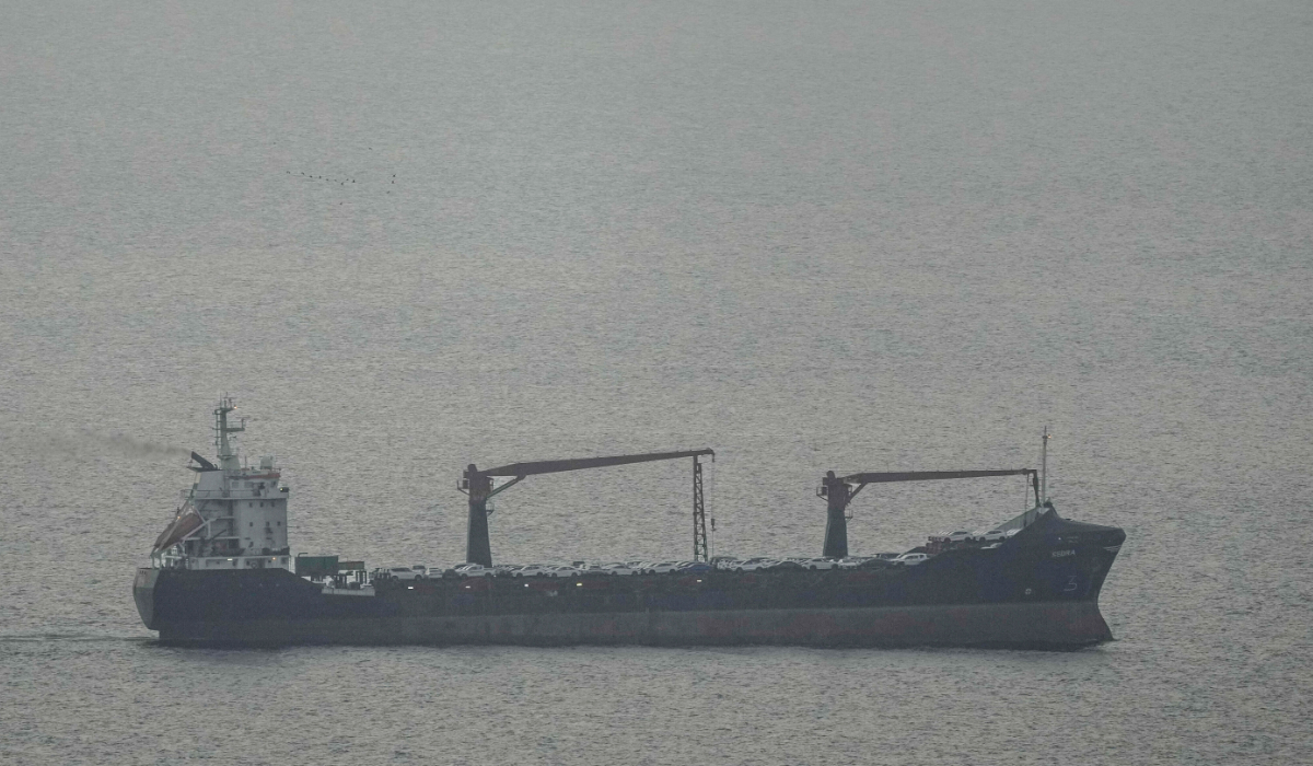 A cargo ship carrying vehicles sails through the Arabian Gulf toward the Strait of Hormuz in the United Arab Emirates, Sunday, March 22, 2026. (AP)