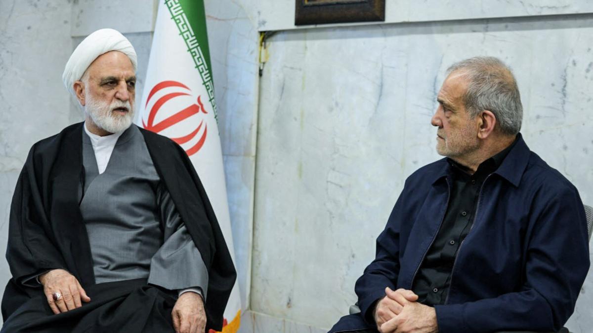 A handout photo made available by the state television station, Islamic Republic of Iran Broadcasting News (IRIBNEWS) on March 2, 2026, show the second meeting of the Interim Leadership Council attended by Judiciary Chief Gholamhossein Mohseni Ejei (L) and President Masoud Pezhakian (R), in Tehran. (AFP)