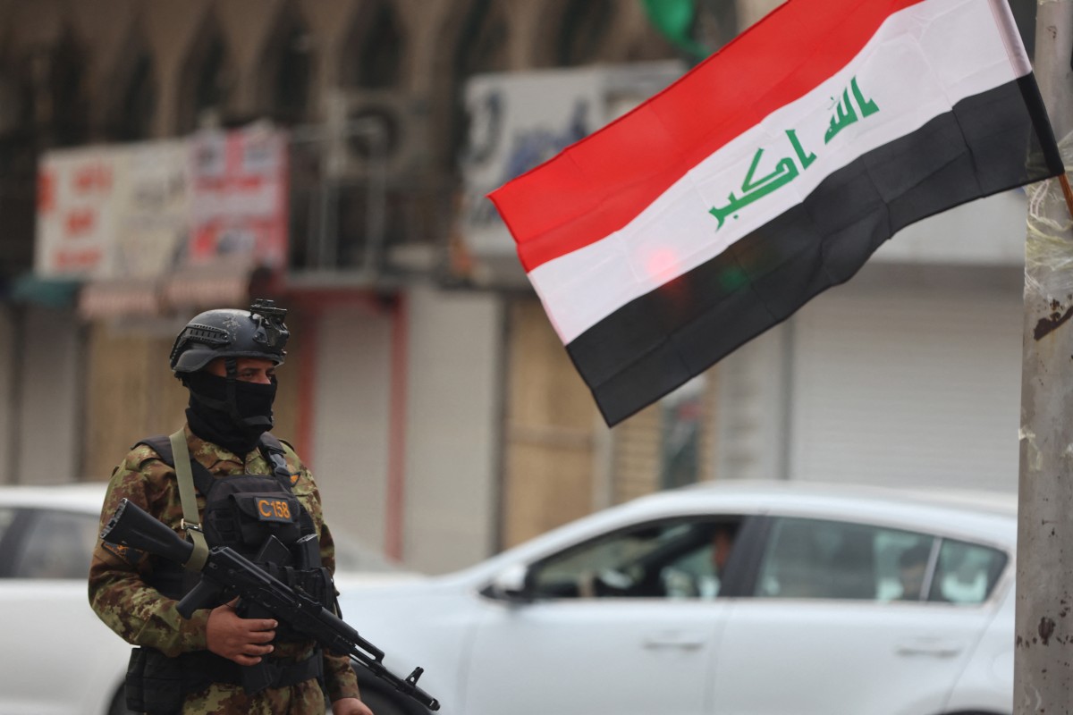 A member of Iraq's Hashed al-Shaabi forces stand guard during a pro-Iran rally in Tahrir Square in Baghdad, Iraq. (AFP)