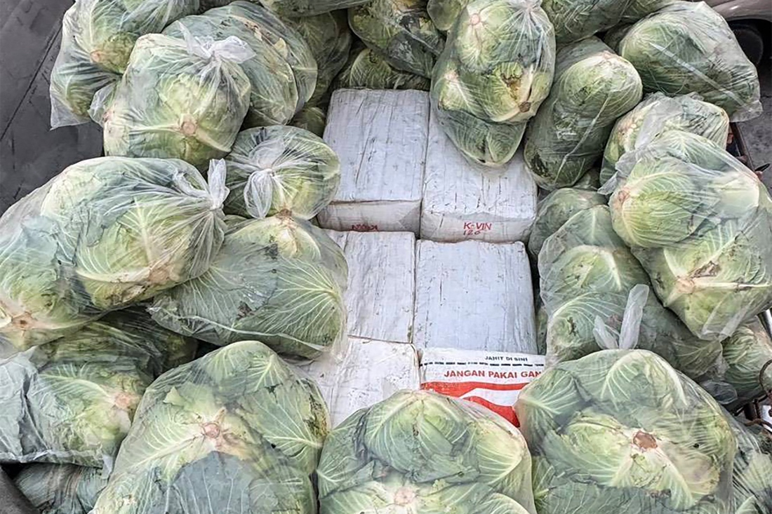 This handout from Bangkok's Metropolitan Police Bureau shows boxes containing ketamine and crystal methaphetamine buried under cabbages in the bed of a pickup truck in Ayutthaya province, Thailand. (AFP)