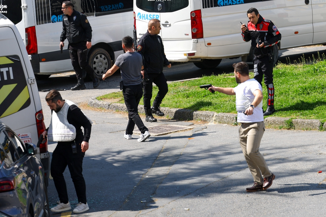 A man holds a gun, after gunfire was heard near the building housing the Israeli consulate, according to a witness, in Istanbul, Turkiye, April 7, 2026. (REUTERS)