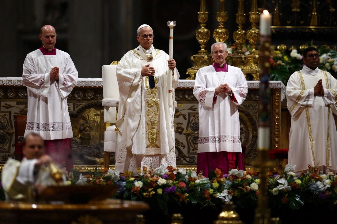 Pope Leo XIV holds a candle as he leads the Easter Vigil in Saint Peter's Basilica at the Vatican. (Reuters)