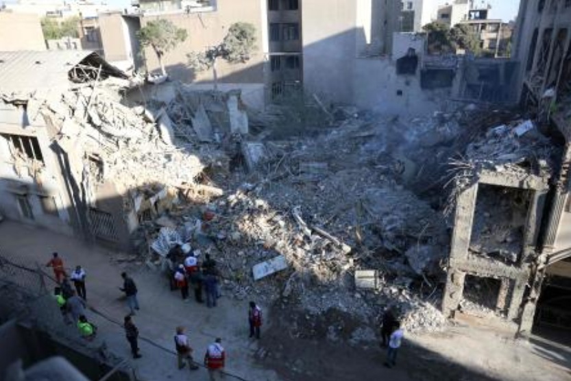 Iranian workers and volunteers gather at the site of Israeli-American strikes that according to local media reported destroyed the Rafi-Nia Synagogue and nearby residential buildings in Tehran, on Apr. 7 2026. (AFP)