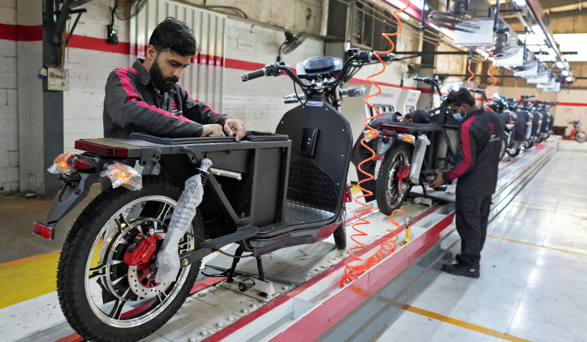 Workers assemble parts of electric motocycles on the production line at the ZYP Technology's facility in Lahore, Pakistan, March 12, 2025. (REUTERS)