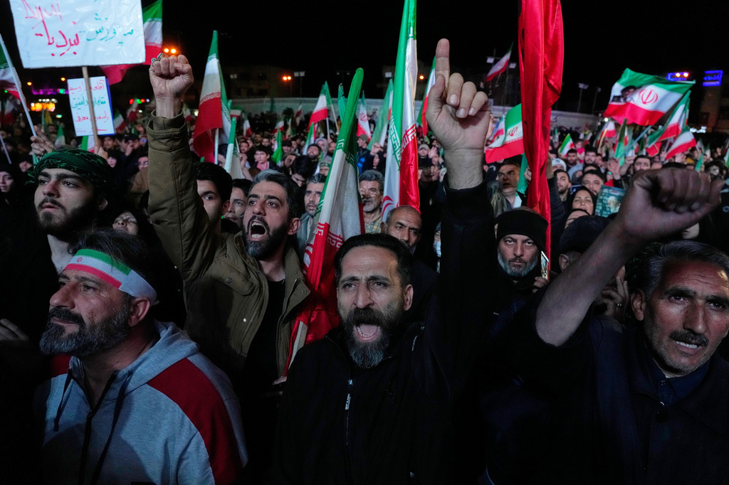 Iranian pro-government demonstrators chant slogans in a gathering after announcement of a two-week ceasefire in the war with the United States and Israel, at the Enqelab-e-Eslami, or Islamic Revolution, Square, in Tehran, Iran, Wednesday, April 8, 2026. (AP)