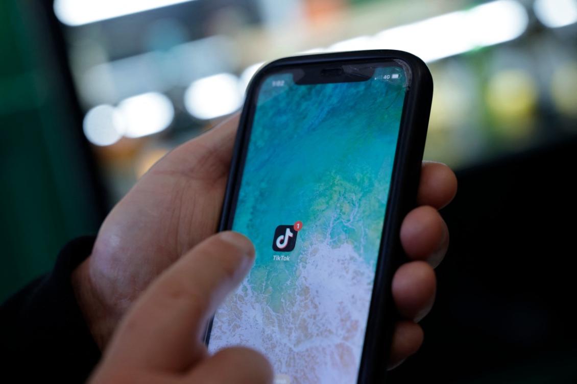 An internet user scrolls through TikTok in Durres on February 5, 2026. (AFP)