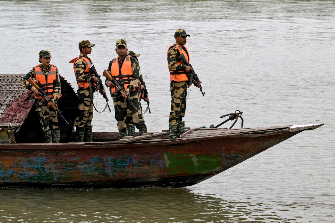 Border Security Force (BSF) personnel riding a boat patrol along the Gangadhar river near the India-Bangladesh border in Golakganj, Dhubri district in India’s Assam State. (AFP)