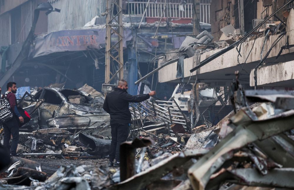 People stand at the site of an Israeli strike in Al-Mazraa, Beirut, Lebanon, Apr. 8, 2026. (Reuters)