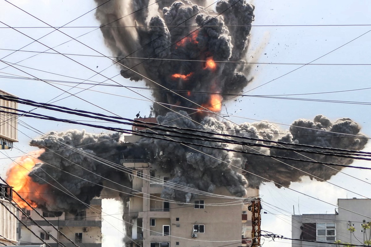 A fireball rises from a building hit by an Israeli airstrike in the area of Abbasiyeh, on the outskirts of the southern Lebanese city of Tyre, April 8, 2026. (AFP)