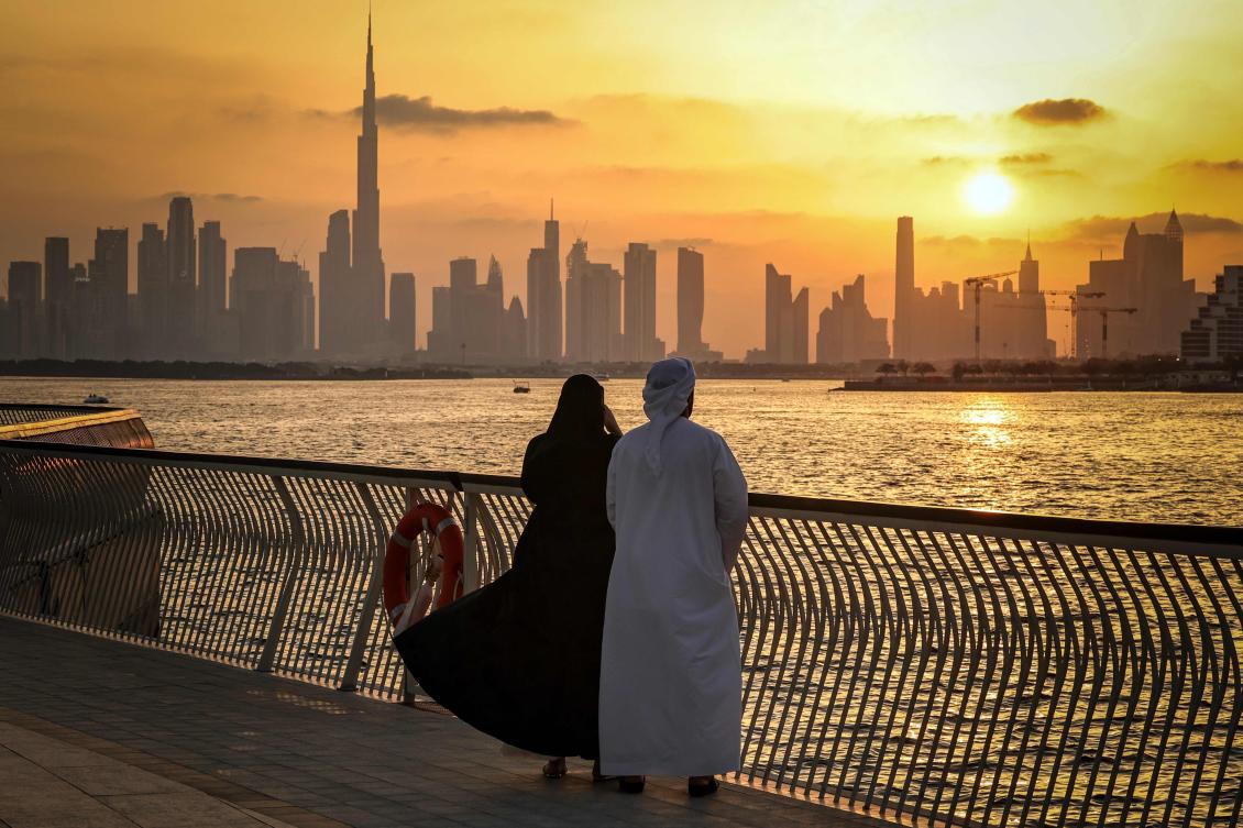A couple stands looking at the Dubai skyline, with the Burj Khalifa, the world’s tallest building, seen from Creek Harbour on April 3. (AFP)