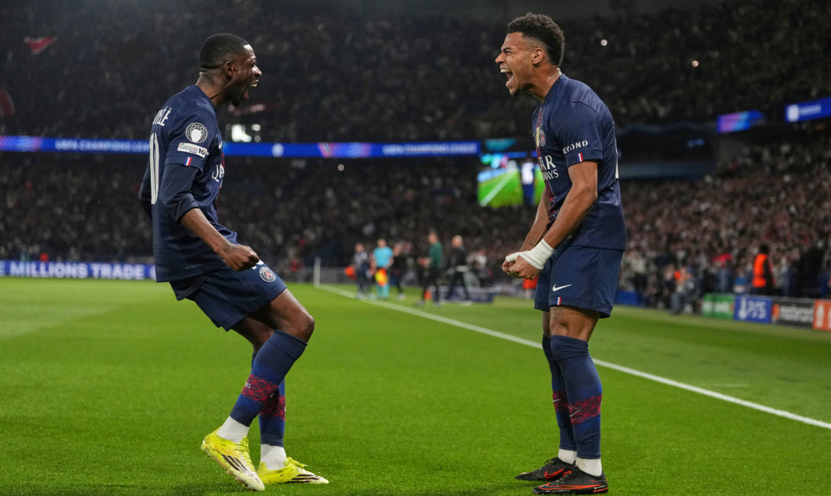 PSG's Desire Doue, right, celebrates with PSG's Ousmane Dembele after scoring the opening goal during the Champions League quarterfinal first leg soccer match between Paris Saint-Germain and Liverpool in Paris, Wednesday, April 8, 2026. (AP)