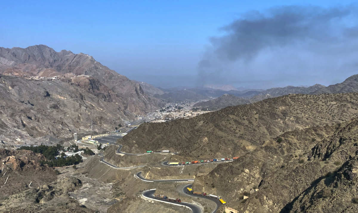 Smoke emits from Afghan side as trucks are parked along roadside following cross-border clashes between Pakistan and Afghan forces, at near Torkham border crossing point, Pakistan, Feb. 28, 2026. (AP)