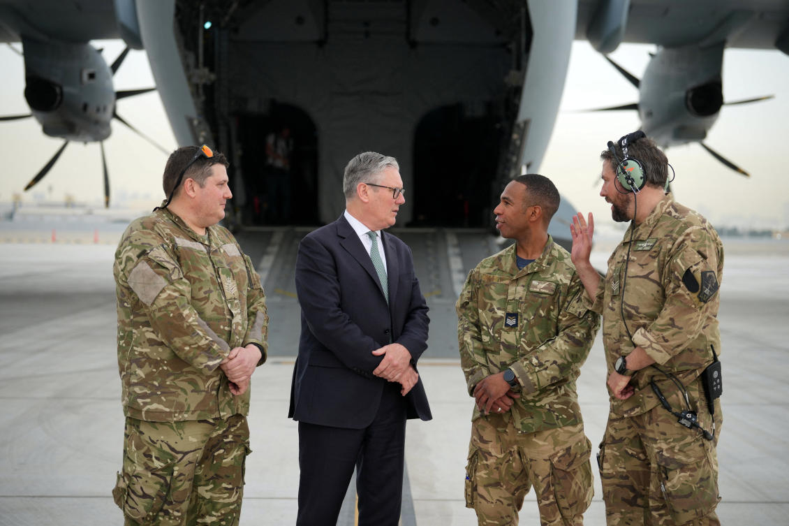 Britain’s Prime Minister Keir Starmer speaks to members of the aircrew before boarding a military plane in Abu Dhabi, UAE. (Reuters)