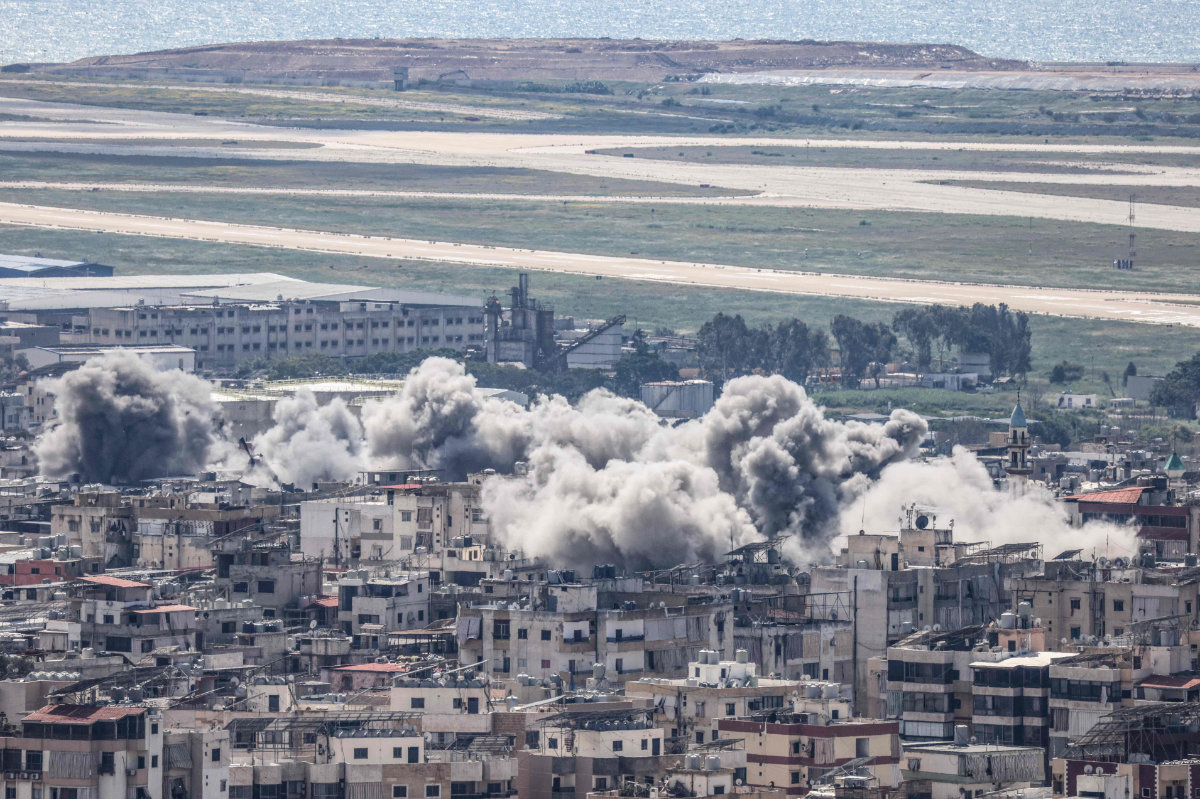 Smoke rises following Israeli airstrikes in Beirut's southern suburbs, with the capital's international airport visible in the background, on April 8, 2026. (AFP)
