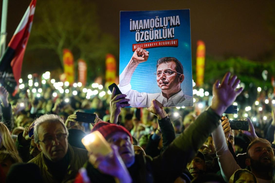 Supporters mark one year since the detention of Istanbul Mayor Ekrem Imamoglu, whose image appears on a poster, during a demonstration at Sarachane Square in Istanbul on March 18, 2026. (AFP)