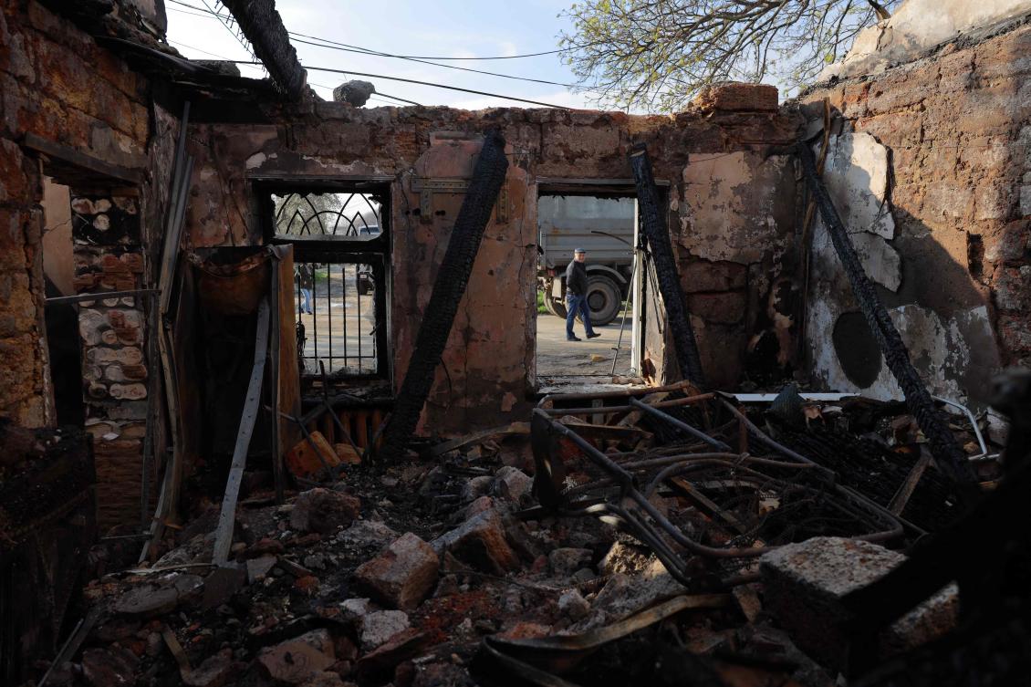 A local resident walks past a destroyed house following an air attack in Odesa on April 11, 2026. (AFP)